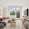 Living room with couch, small table, and dining chairs.