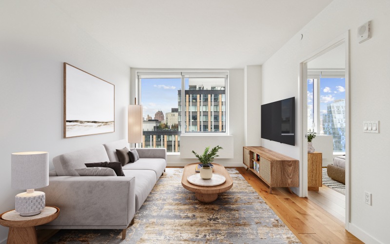 Living room with couch, coffee table, entertainment stand and lots of natural light.