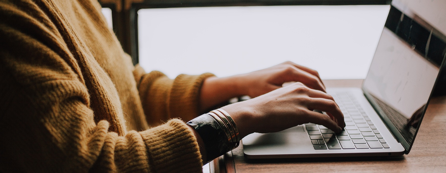 hands typing on a laptop